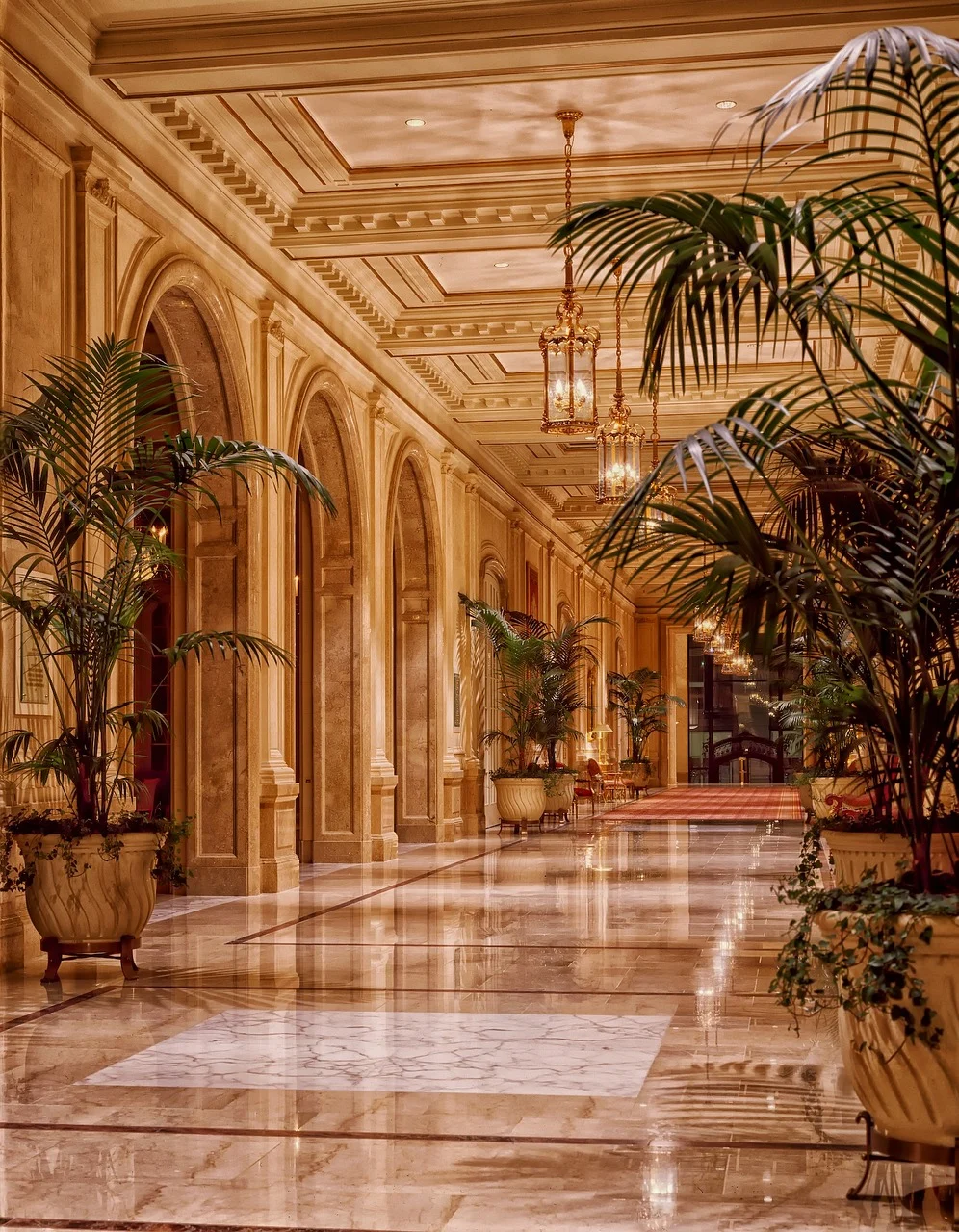 A narrow hallway painted in warm greige matte eggshell soft natural light bouncing off the walls subtle abstract botanical print above minimal trim creating an airy reflective corridor