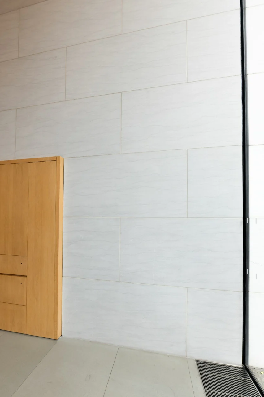A wooden door and modern, white walls