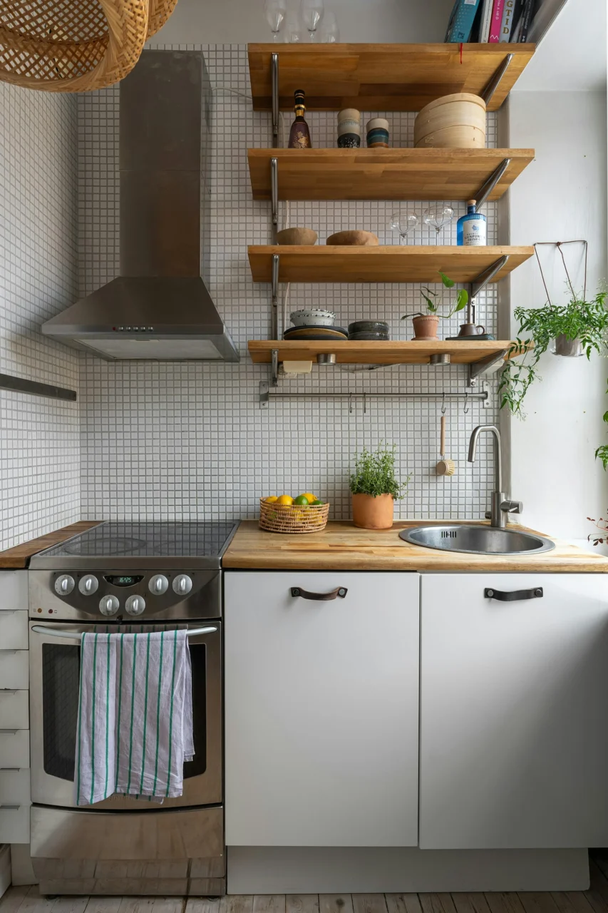 How to Decorate a Rental Kitchen Without Drilling interior: 6. Define Zones with Portable Room Dividers or Rolling Carts - In many rentals the kitchen flows directly into a dining or living area, making it hard to establish a dedicated cooking zone. A lightweight folding screen or a rolling kitchen cart can act as a