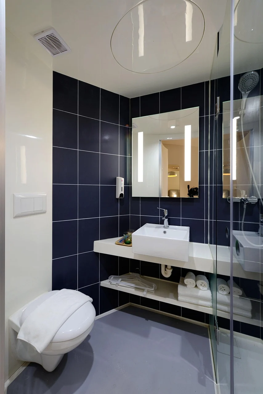 How to Organize a Small Bathroom Without Installing More Cabinets interior: 5. Use Coordinated Baskets and Bins to Contain Loose Items - Soft woven baskets, clear acrylic bins, or metal trays can sit on the countertop or on a low shelf, corralling items that would otherwise scatter. A set of three baskets—one large for toilet paper rolls,